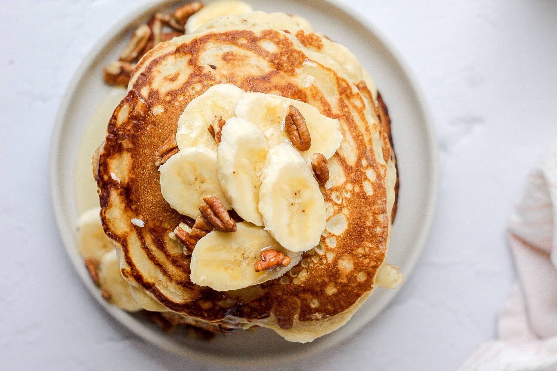 sourdough pancakes with sliced banana and pecans