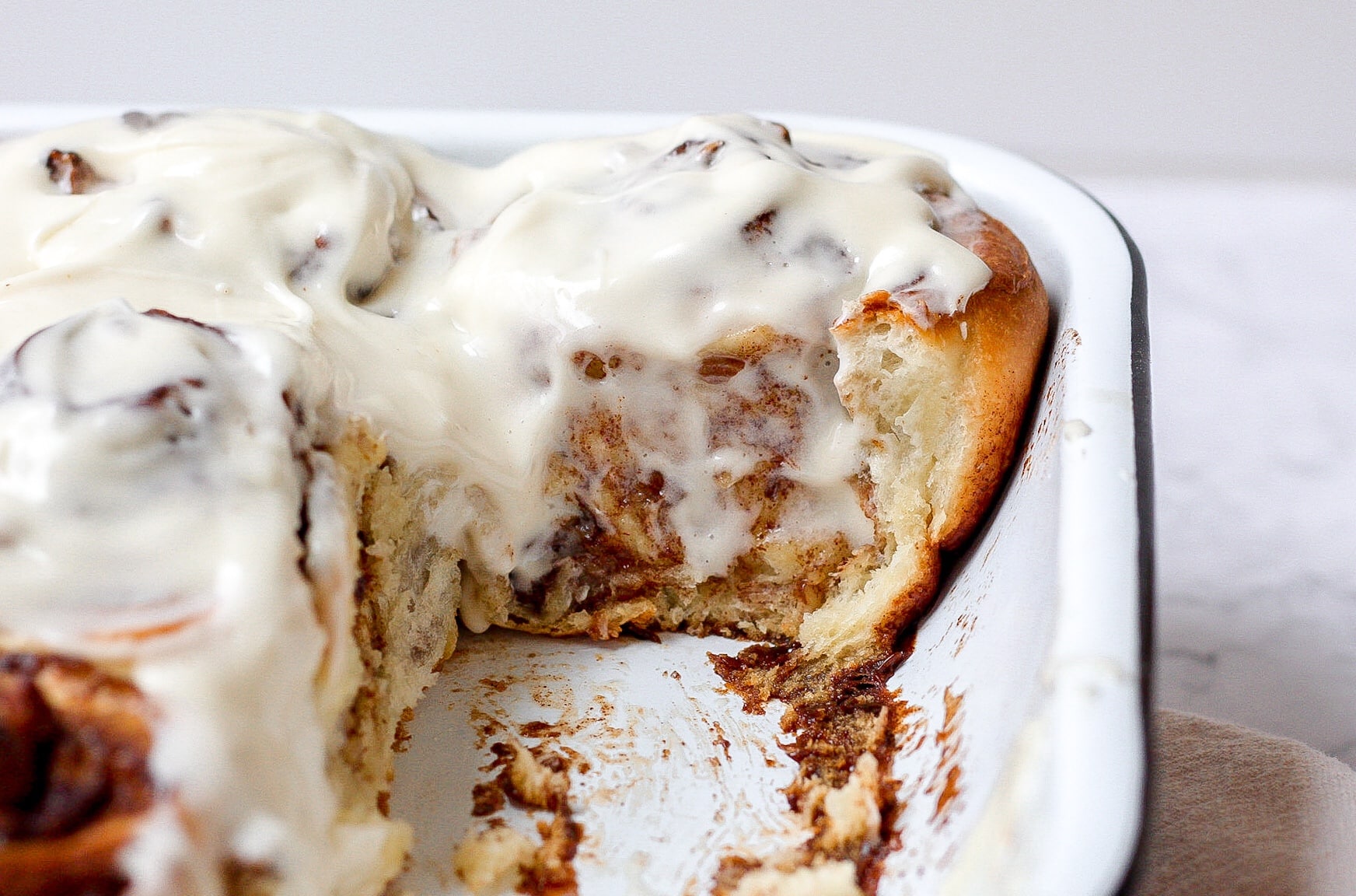 side view of sourdough cinnamon roll with cream cheese icing