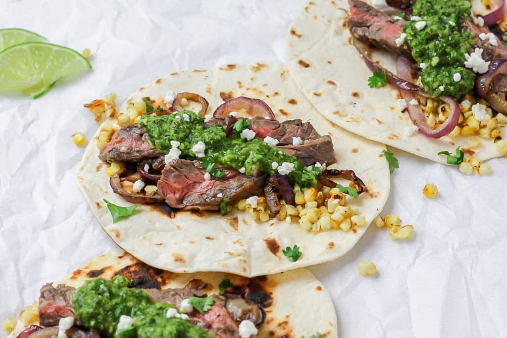 chimichurri steak tacos with grilled onions and corn