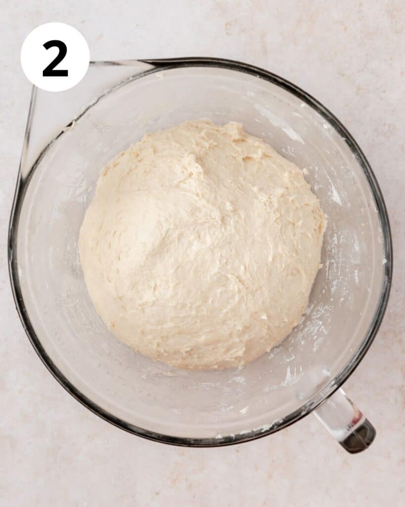 smooth ball of sourdough naan dough in ball
