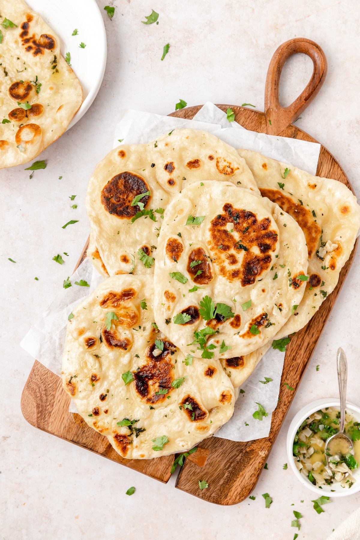sourdough naan with garlic herb butter on cutting board