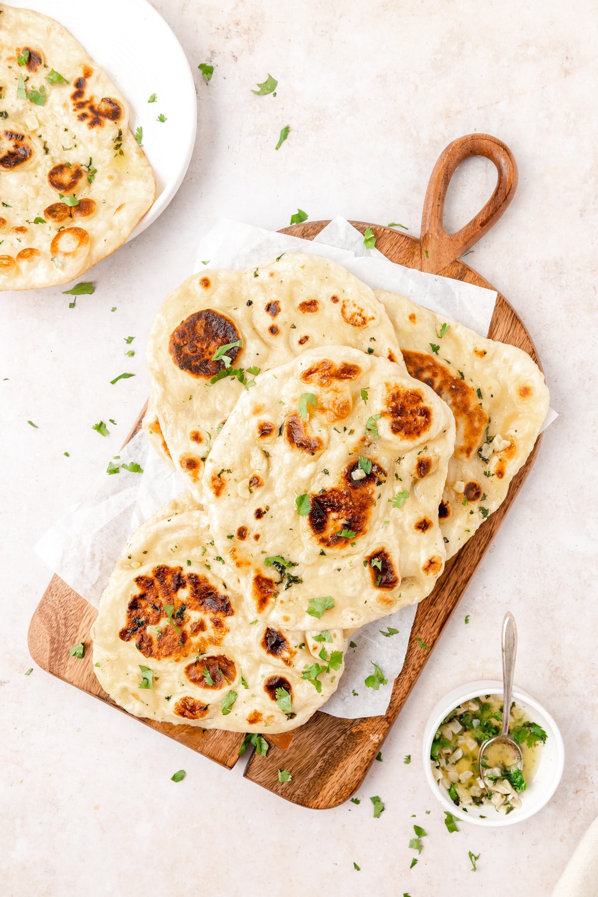 sourdough naan with garlic butter on wood serving board