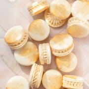 close up shot of champagne macarons with gold paint