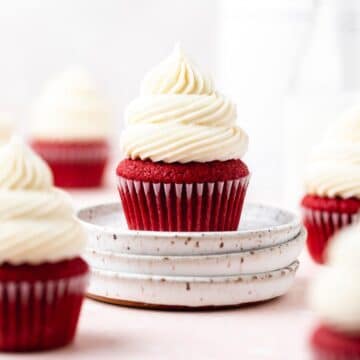 close up shot of red velvet cupcakes with cream cheese frosting.