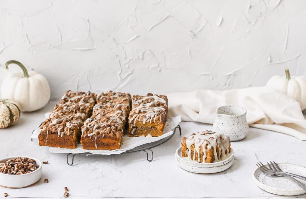 brown butter pumpkin spice coffee cake with drizzled glaze on top