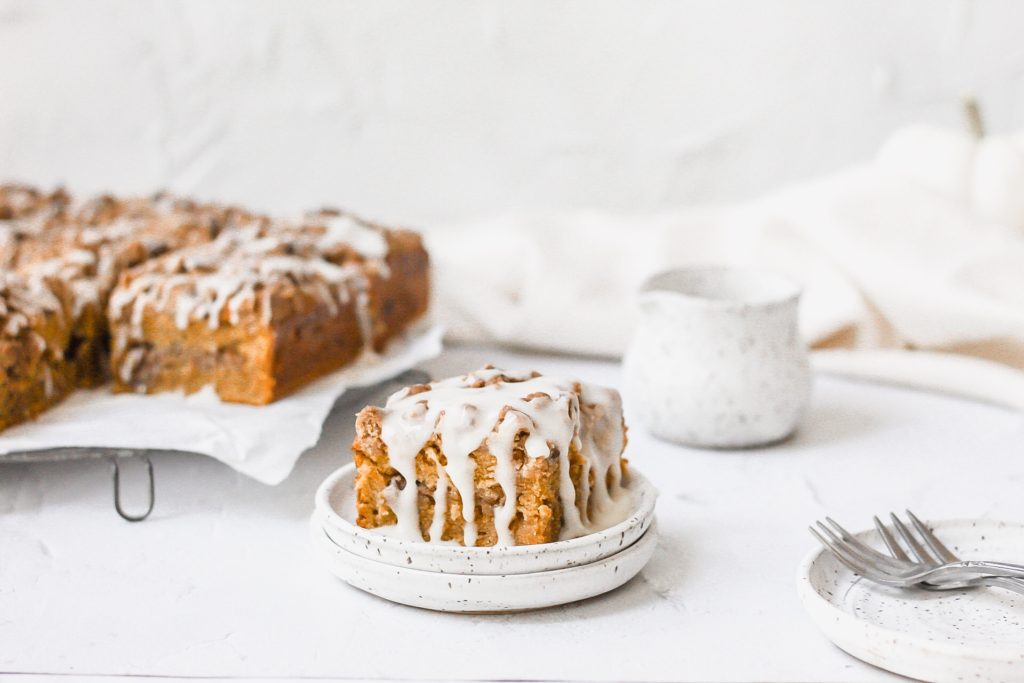brown butter pumpkin spice coffee cake with drizzled glaze on top