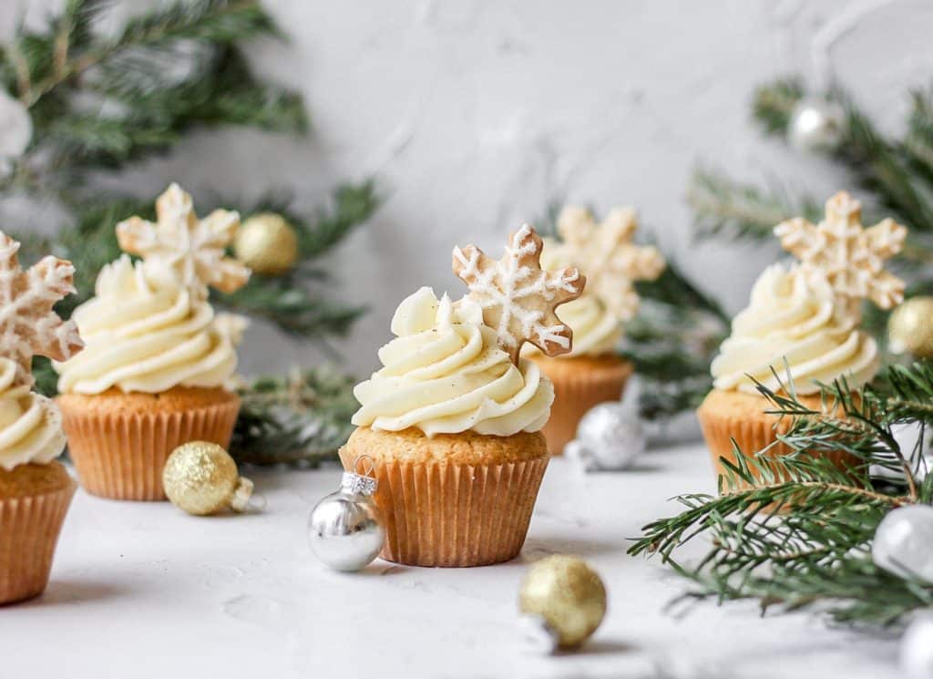 bourbon eggnog cupcakes with eggnog buttercream and topped with a christmas cookie