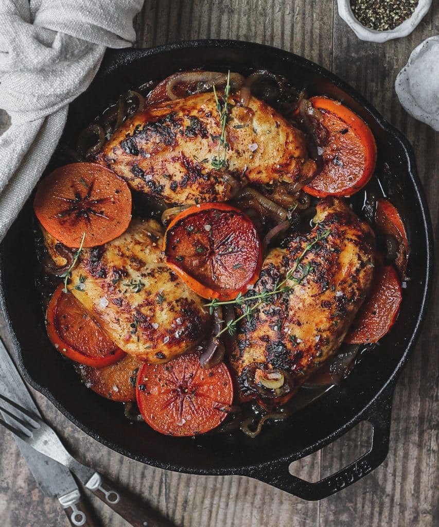 harissa and persimmon chicken in cast iron skillet