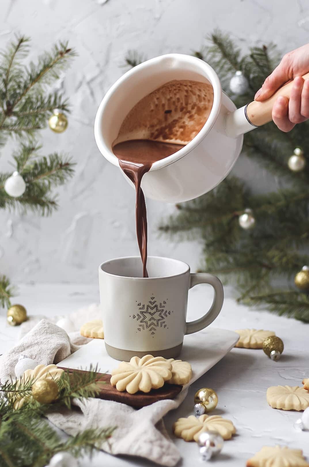 homemade cinnamon hot chocolate being poured into mug
