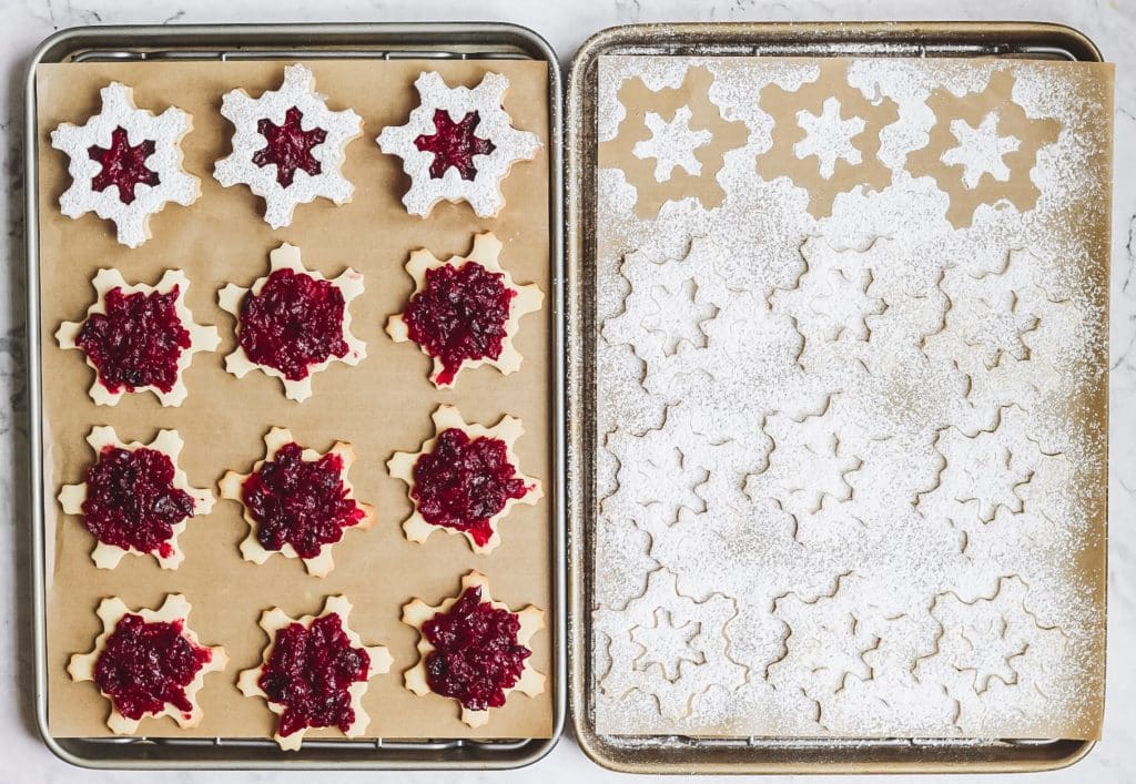 cranberry linzer cookies shaped like snowflakes  before being assembled 