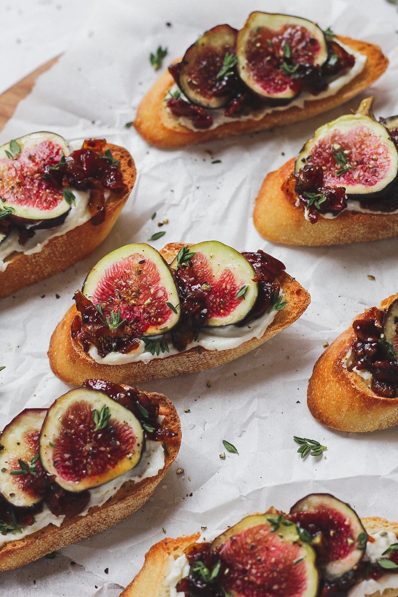 close up shots of crostini with sliced figs and bacon jam