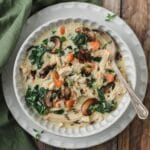 close up shot of bowl chicken wild rice soup with kale and mushrooms