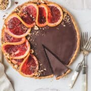 blood orange hazelnut chocolate tart topped with sliced blood oranges
