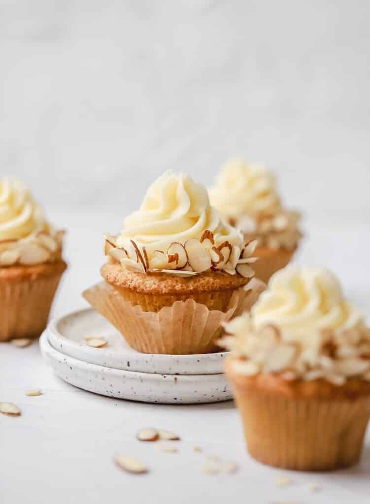 brown butter almond cupcakes with wrapper peeling off