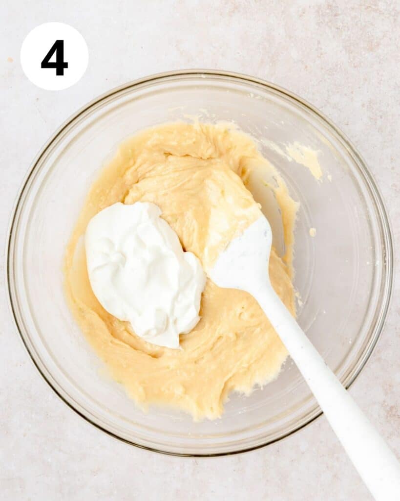 adding yogurt to cupcake batter.