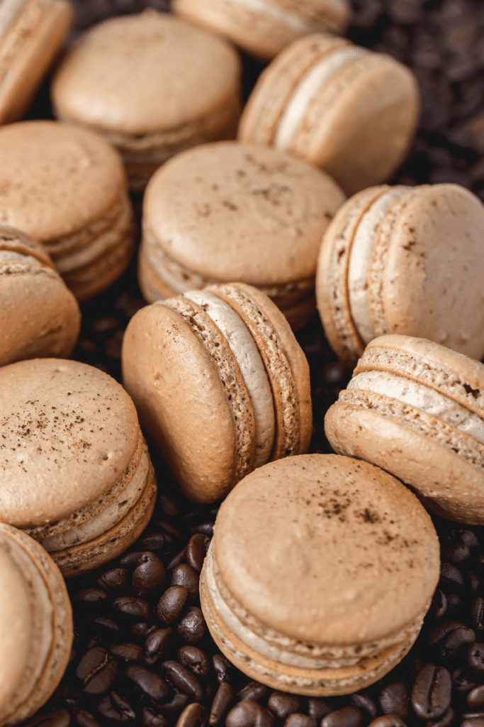 espresso macarons on bed of coffee beans