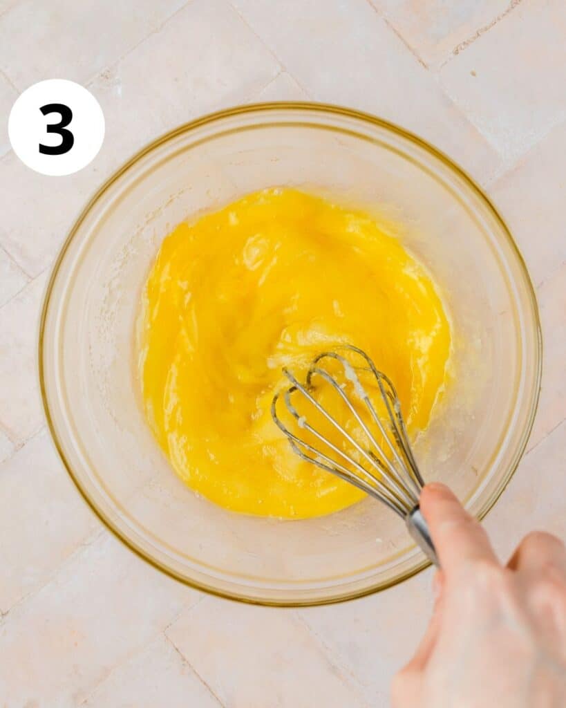 whisking eggs, butter, and sugar in bowl