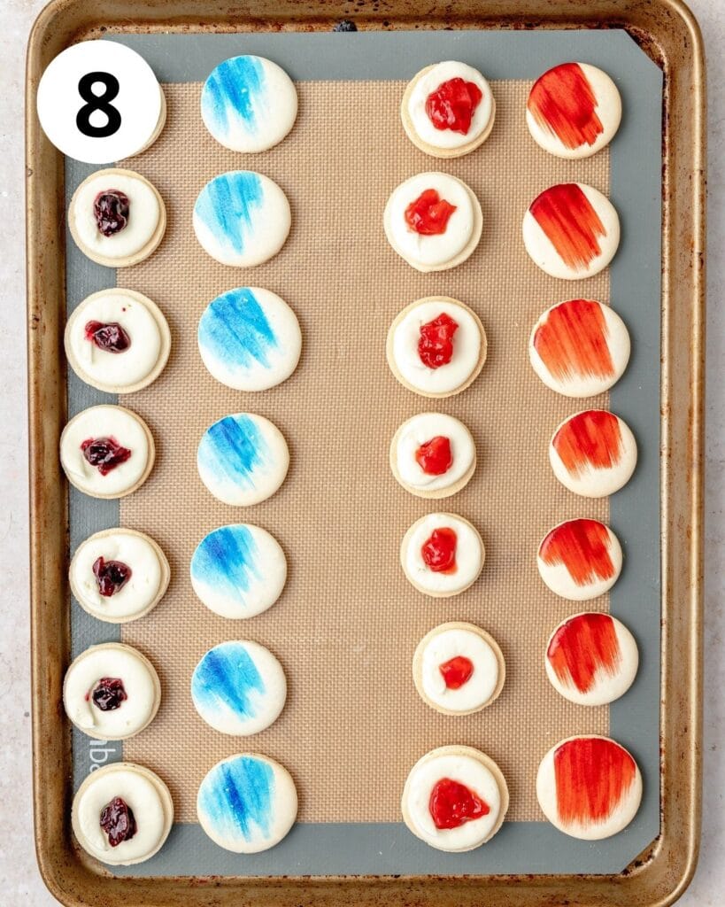 red white and blue painted macarons with cream cheese and berry filling