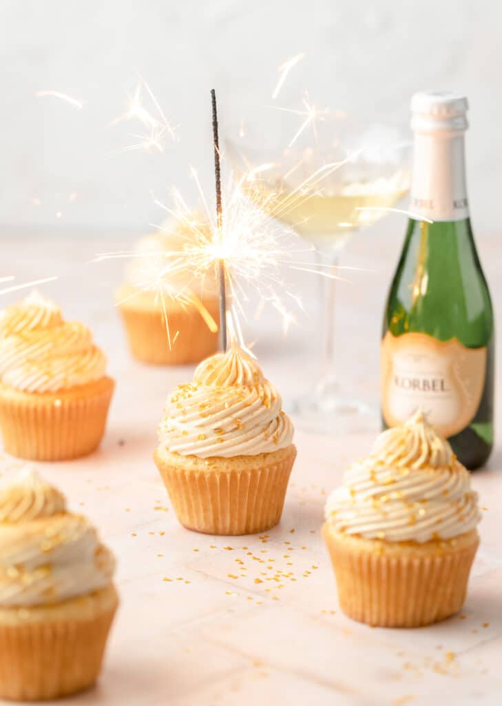 champagne cupcake with sparklers on top.