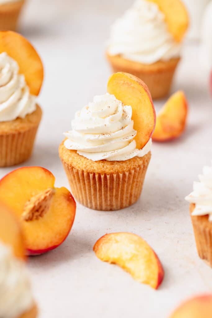 brown butter peach cupcakes with stabilized whipped cream.