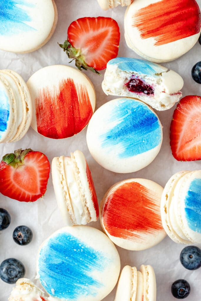 close up shot of red white and blue berry macarons 
