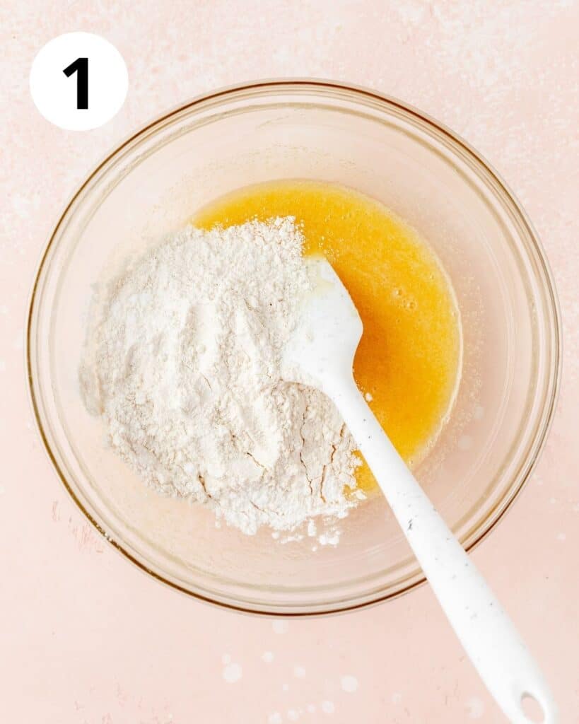 adding flour to wet ingredients for muffins
