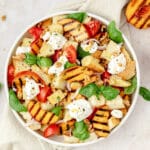 close up shot of grilled peach panzanella salad