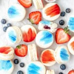 red white and blue berry macarons with blueberries and strawberries