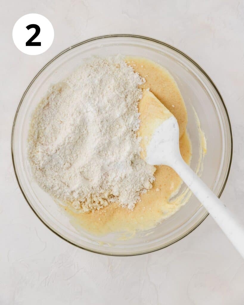 mixing flour into cupcake batter