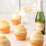 close up shot of champagne cupcakes with sparkler on top