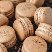 espresso macarons on bed of coffee beans