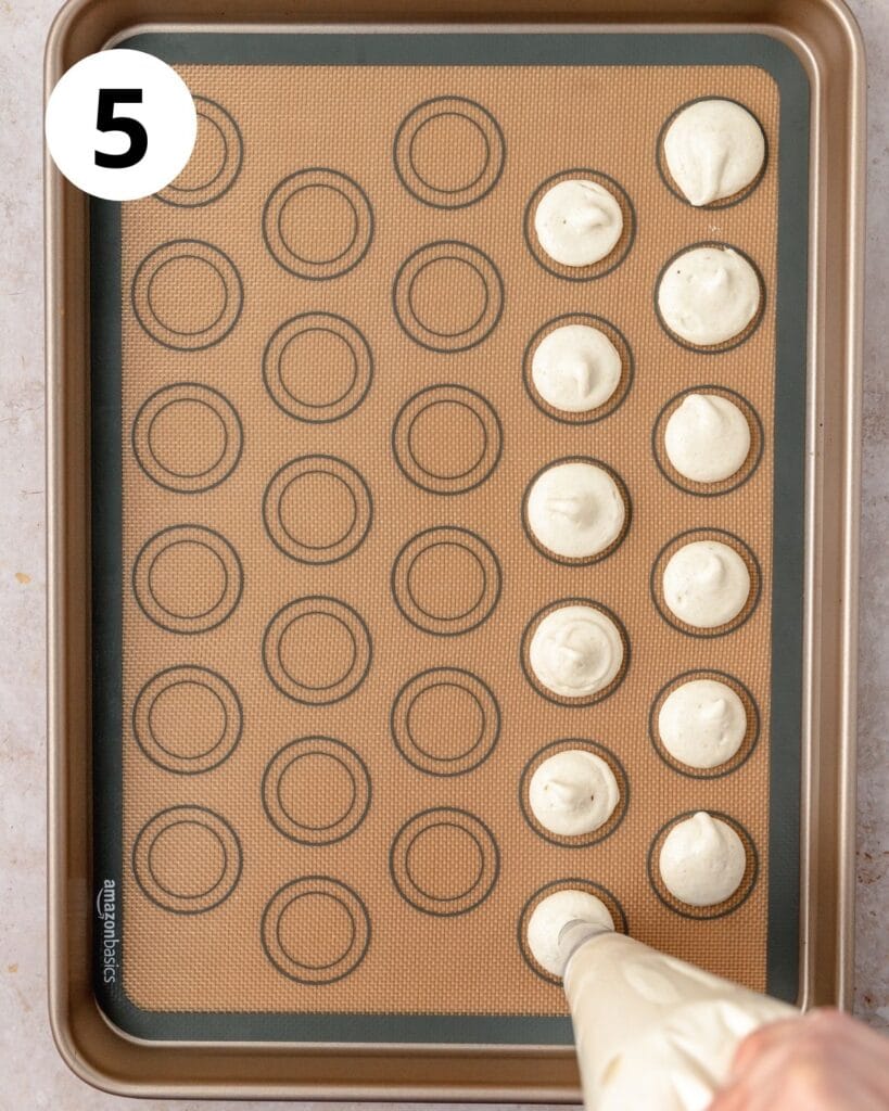 piping vanilla macarons onto baking sheet