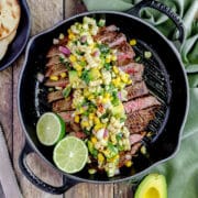 close up shot of grilled flank stead with corn avocado salsa