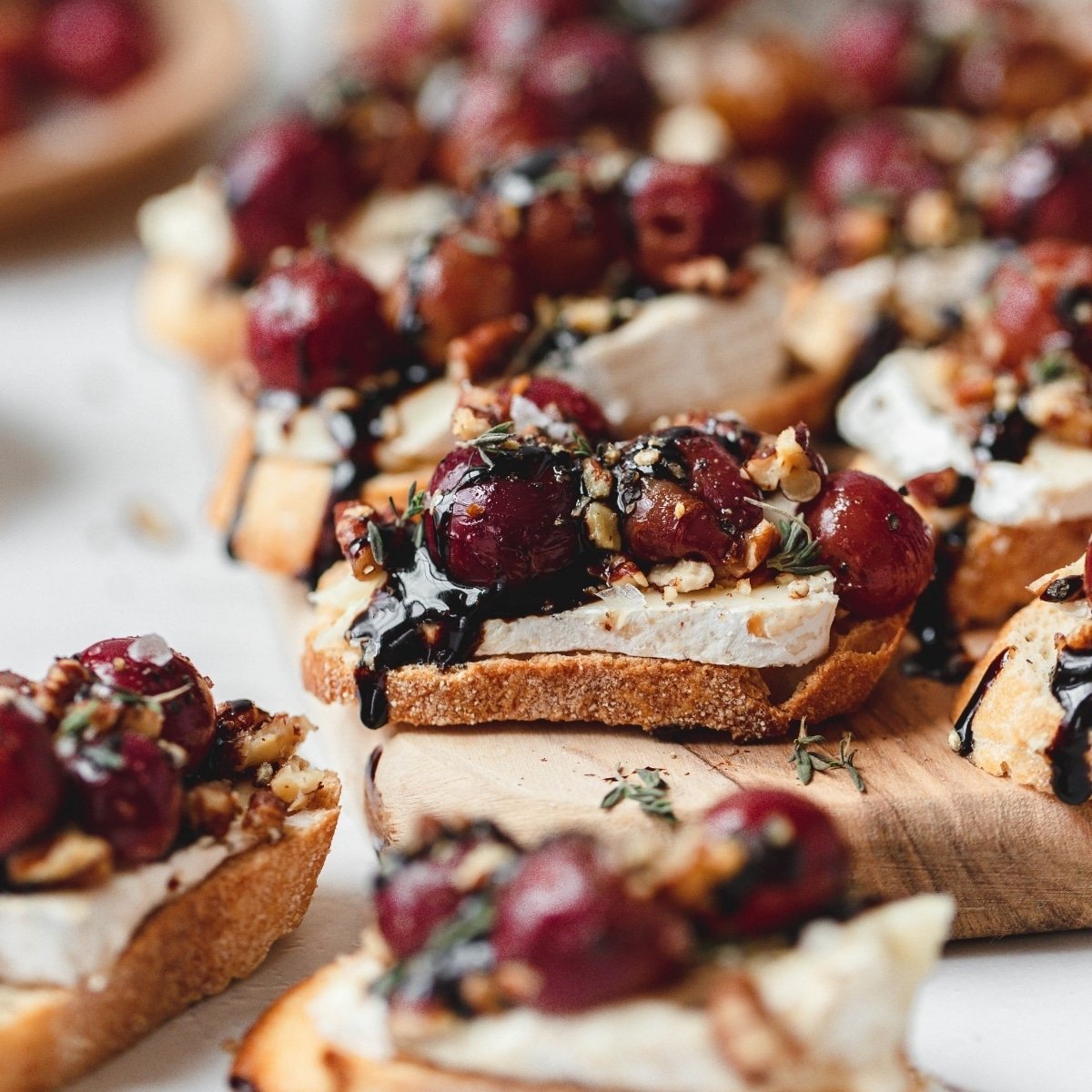 close up shot of balsamic roasted grape crostini