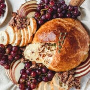 close up shot of baked brie with honey and pecans