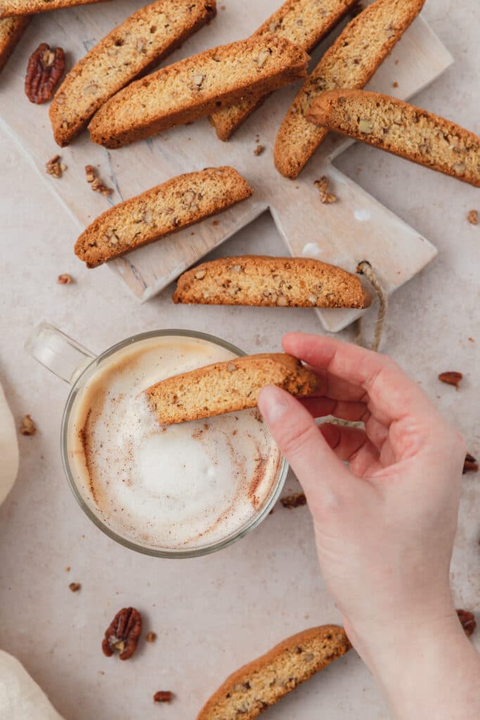 dipping pecan biscotti in latte