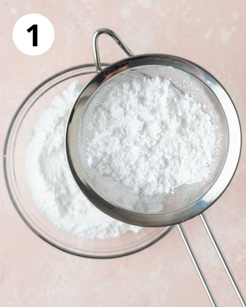 sifting almond flour and powdered sugar into large bowl