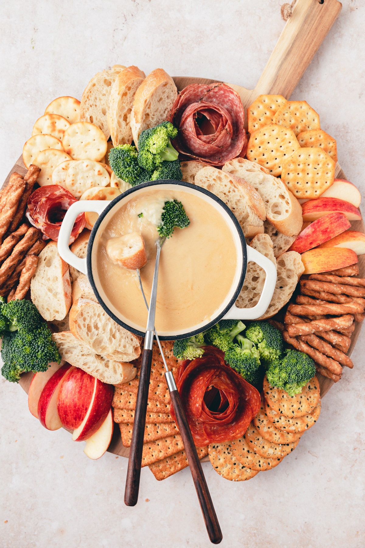 beer cheese fondue with broccoli and bread dipped 