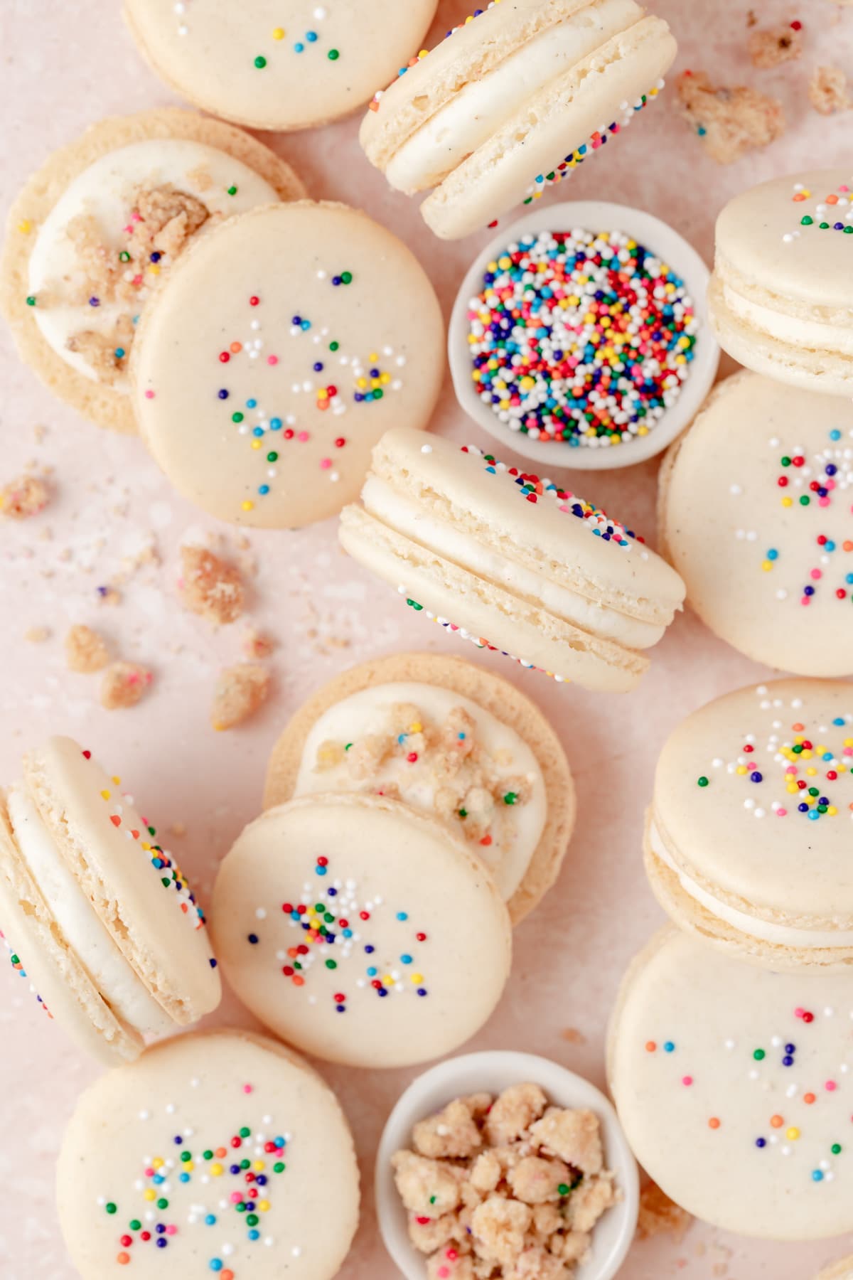 birthday cake macarons with cake crumbs and vanilla frosting 