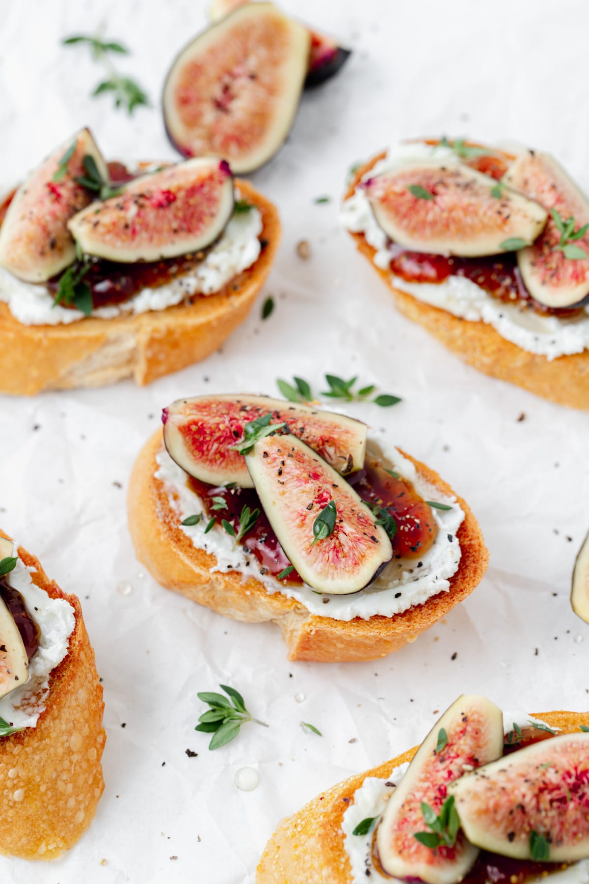 fig and goat cheese crostini with fresh thyme on top