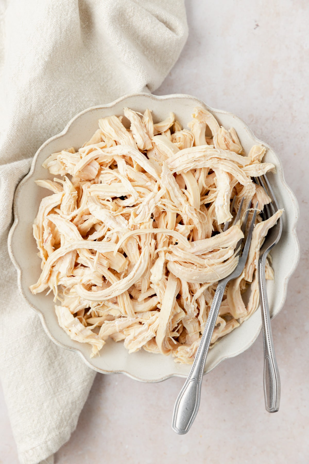 shredded poached chicken in bowl