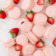 close up shot of strawberry macarons with fresh strawberries