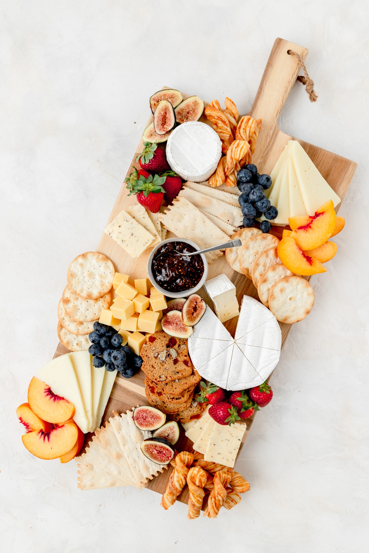 adding fruit to the cheeseboard 
