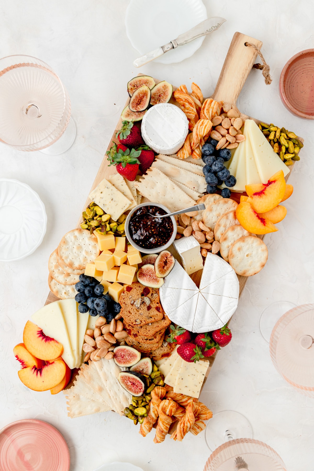 summer cheeseboard with rose wine and small plates