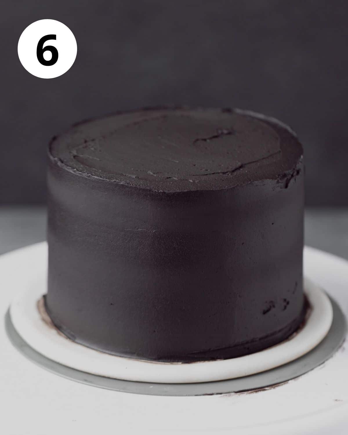 three layer cake with black cocoa buttercream