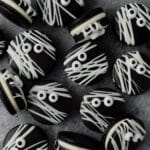 close up of black cocoa mummy macarons