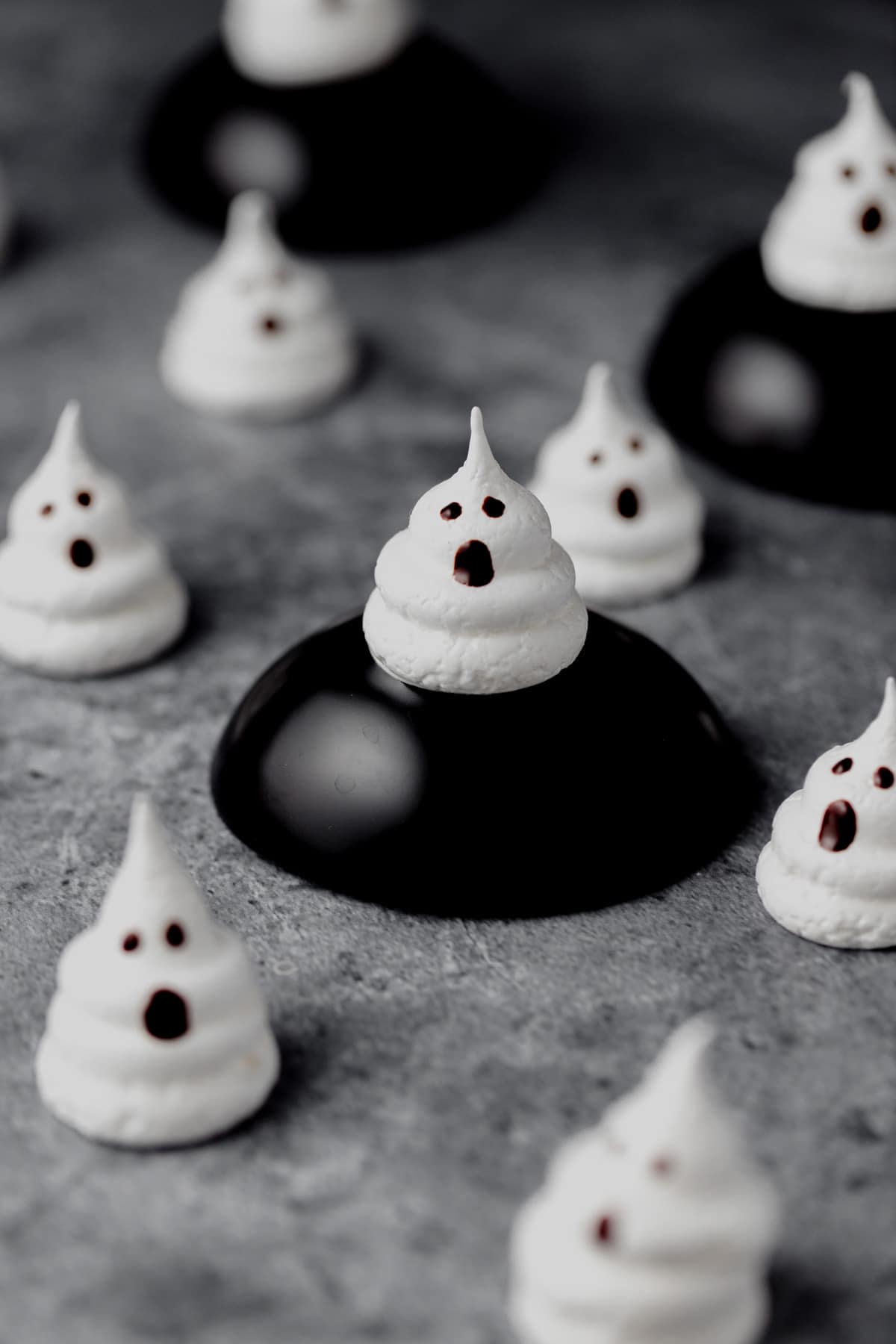 ghost meringue cookies with faces painted on