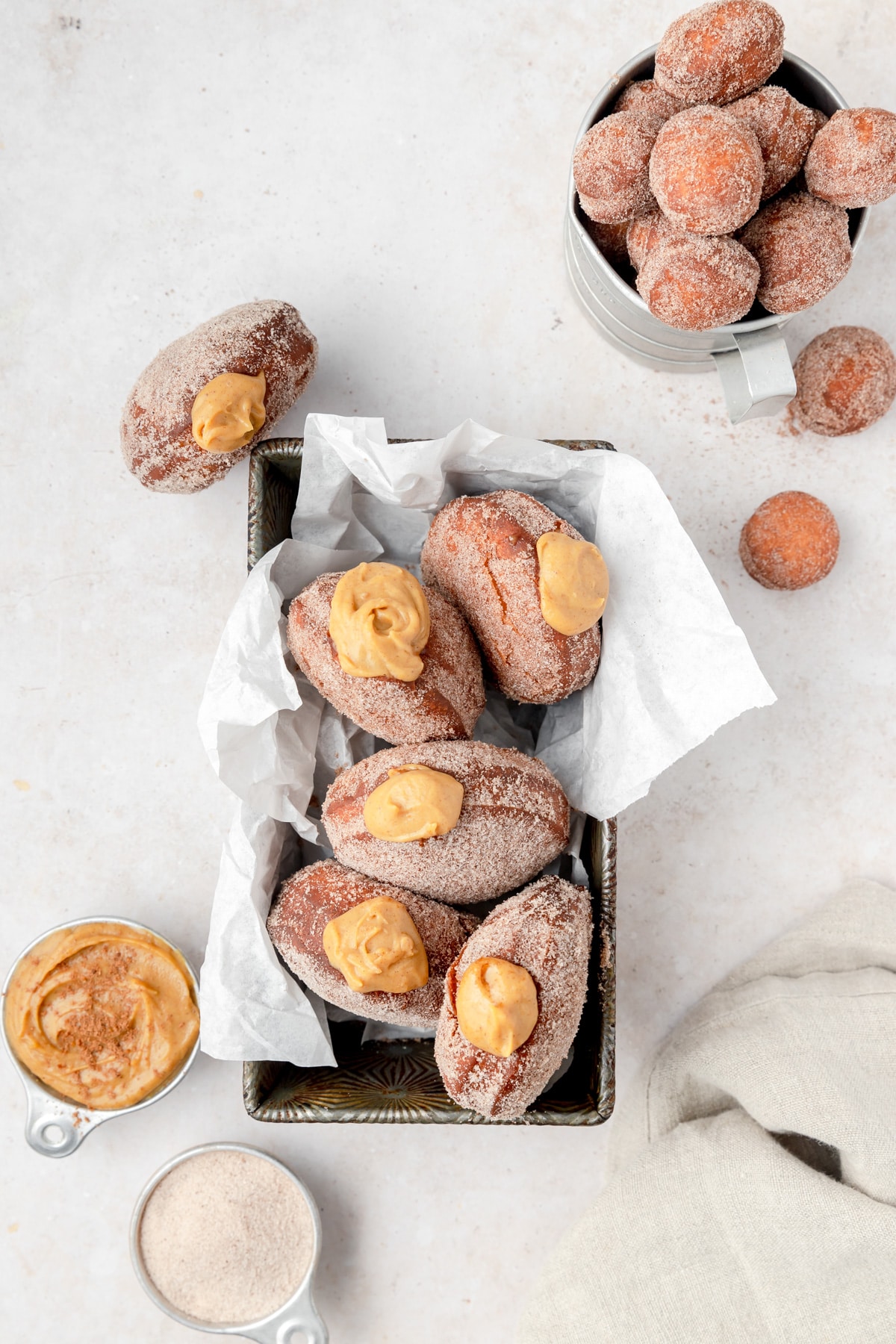 fried donuts filled with pumpkin cream in little tray