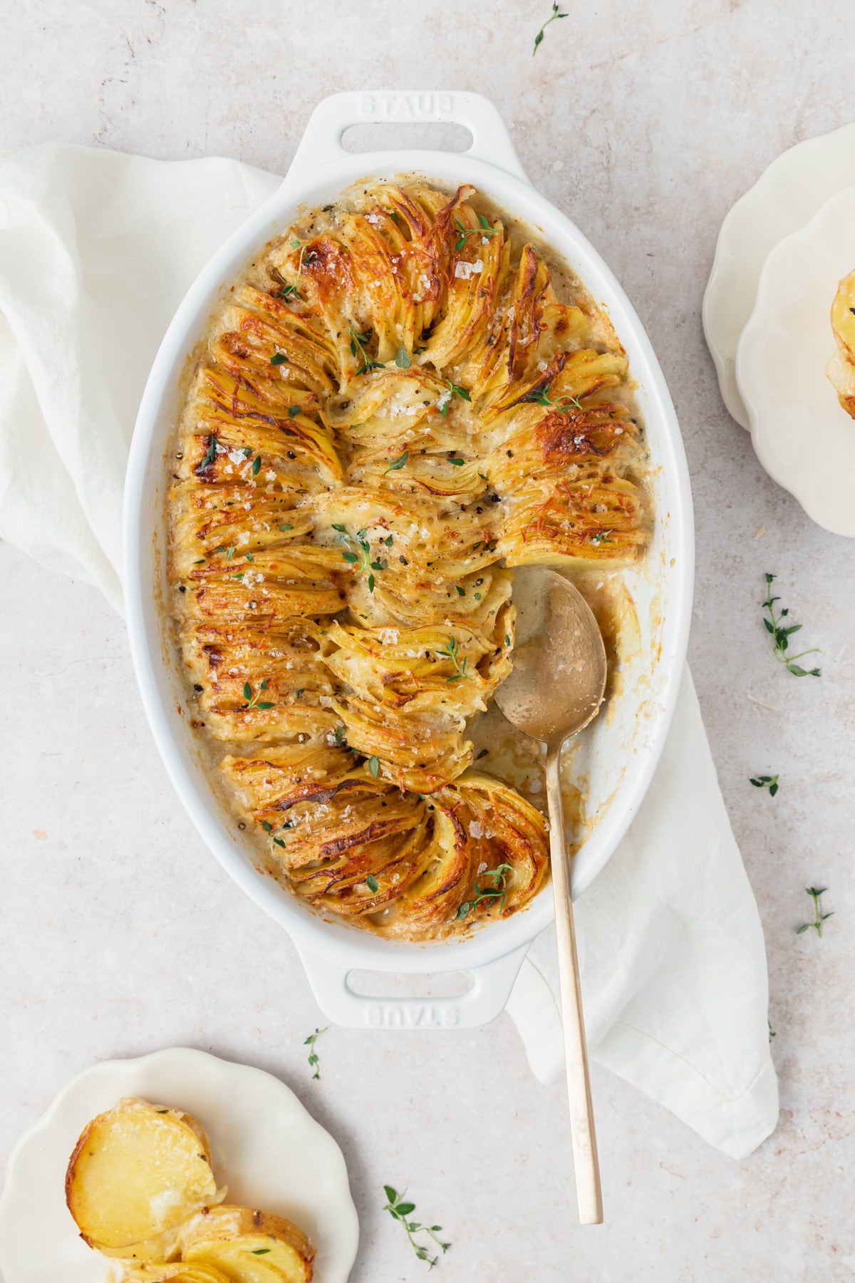 scalloped potatoes with gold spoon