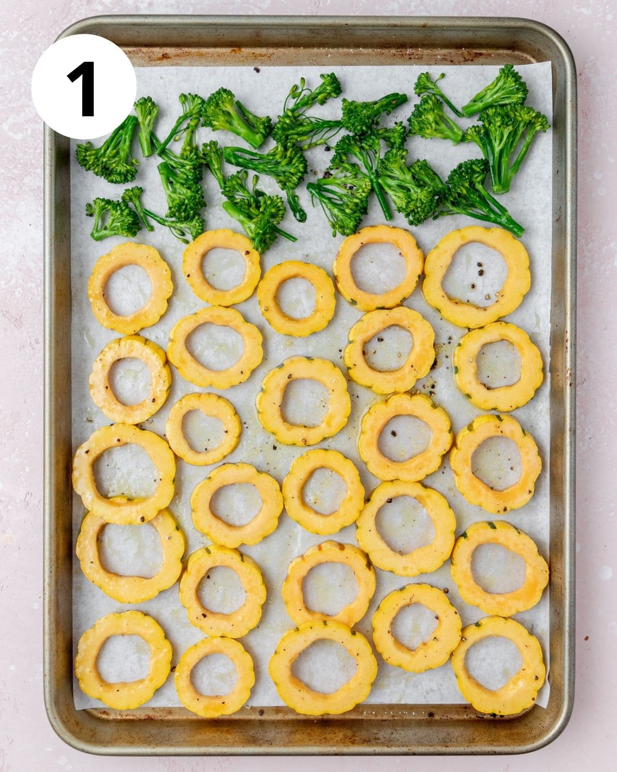 delicata squash and broccolini on baking sheet